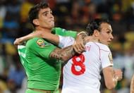Tunisia's Chadi Hammami (R) vies for the ball with Algeria's Carl Medjani in Rustenburg on January 22, 2013